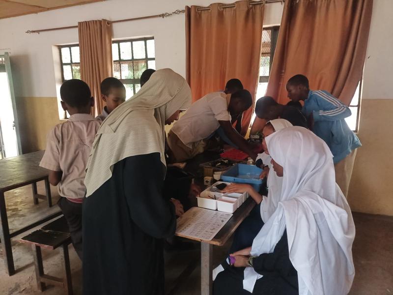 Volunteers helping students with a hands-on activity